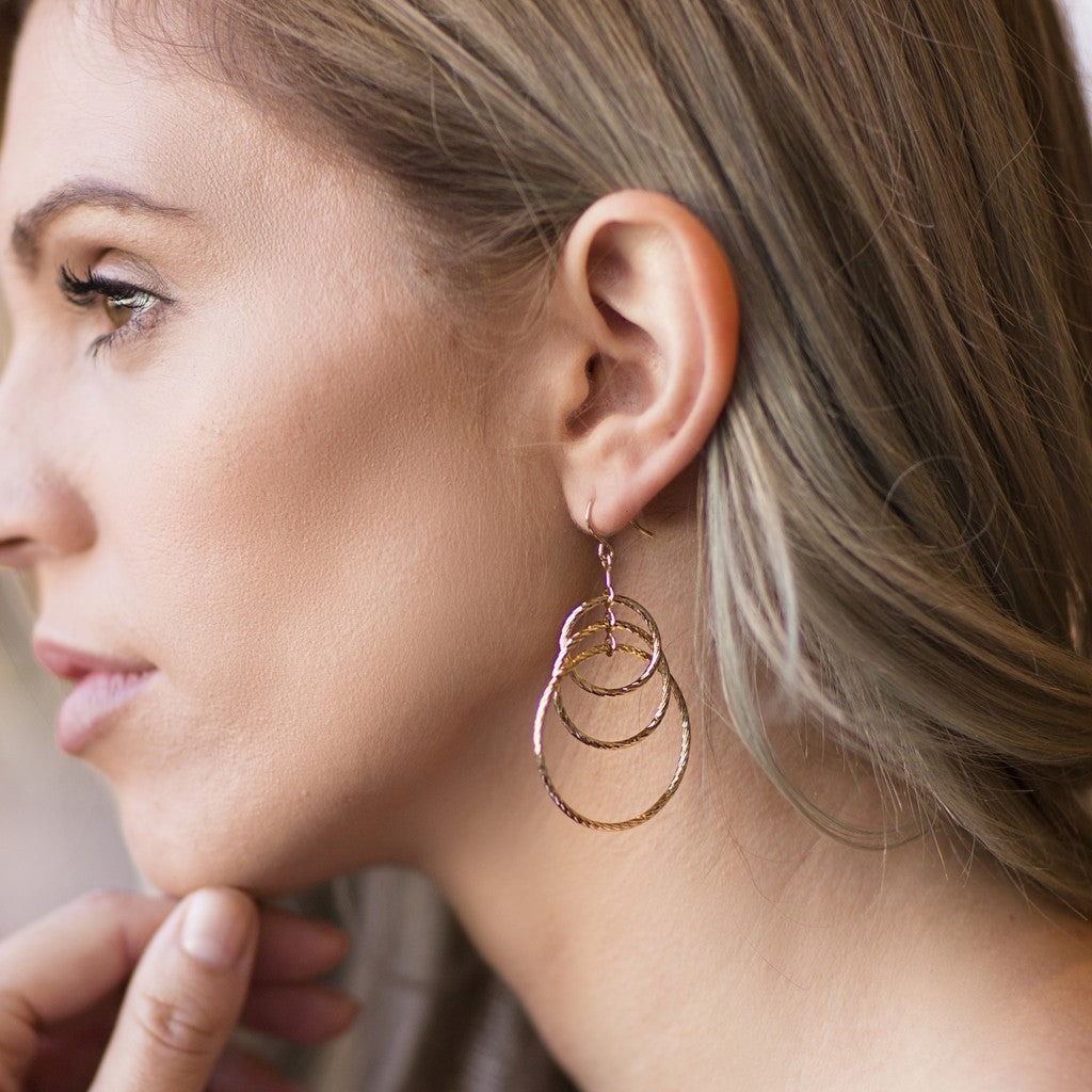 Woman wearing Gold Plated Triple Hoops Earrings